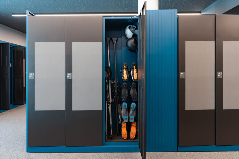 Narty, buty narciarskie i kaski w przechowalni w strefie narciarskiej Valandrea - Livigno